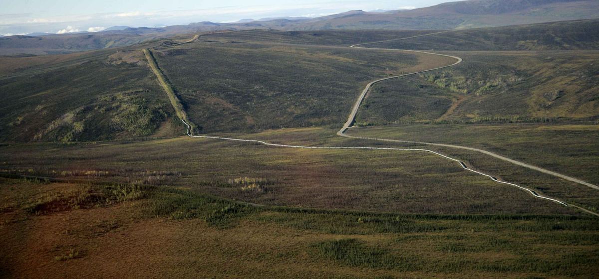Aerial view of a pipeline crossing a tundra valley.